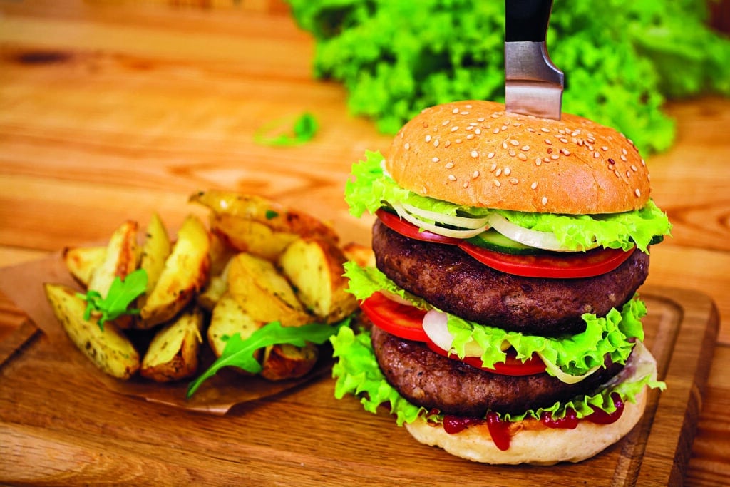 delicious handmade burger on wooden background. close view