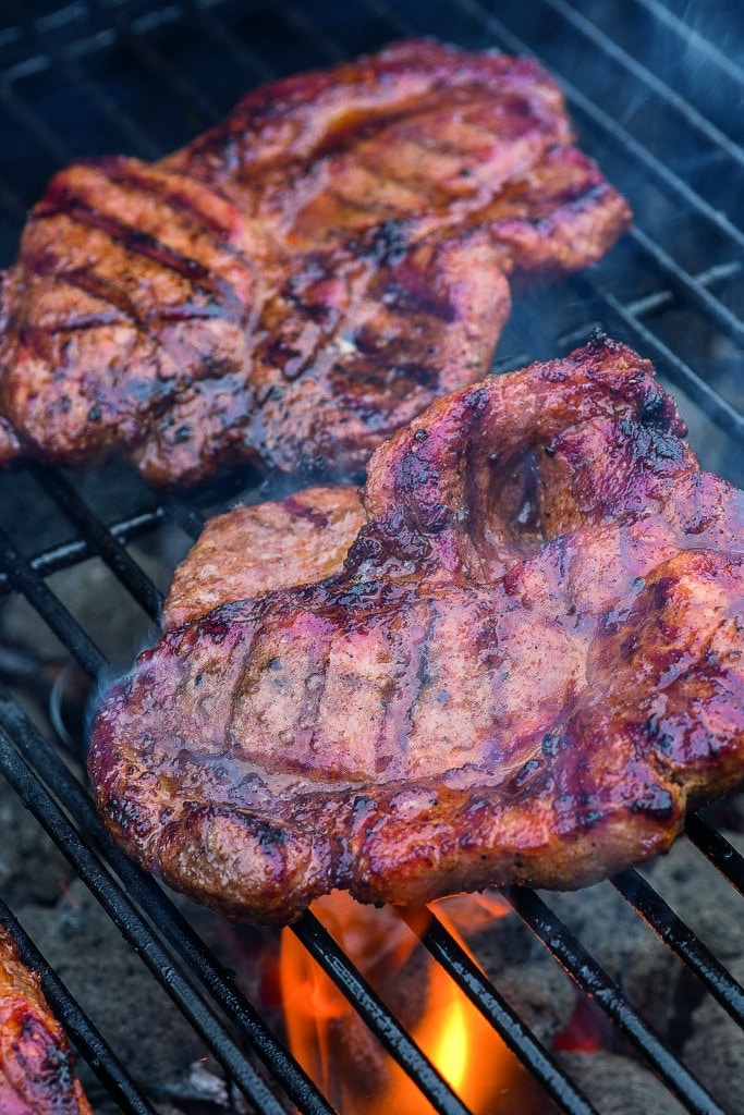 pork steak meat on bbq grill